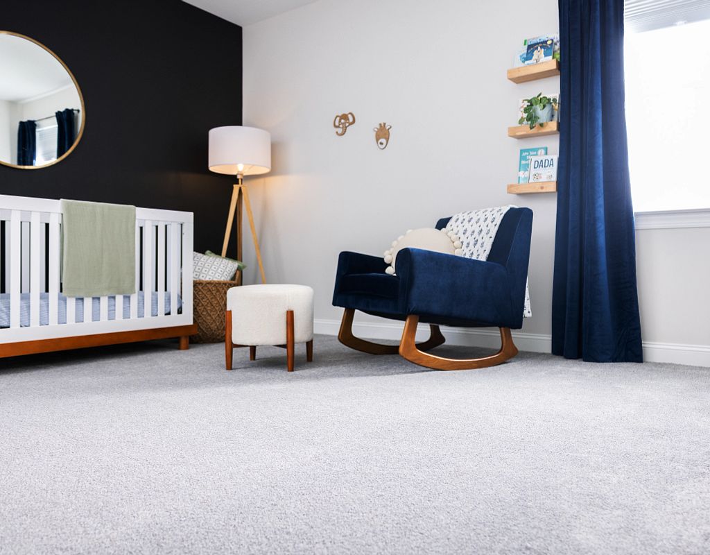 Carpet flooring with blue couch | Custom Floors and Custom Stone