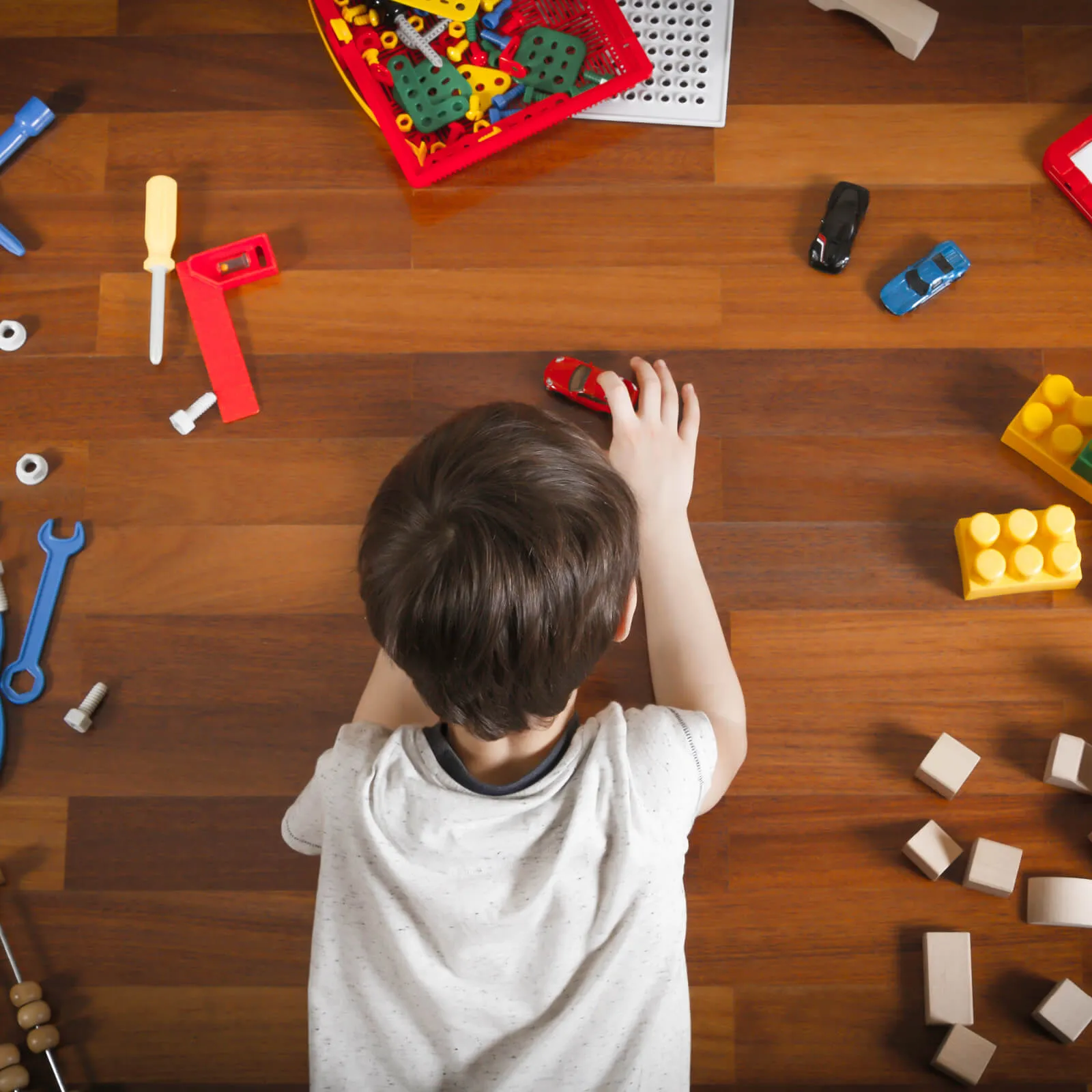 Boy playing with toys | Custom Floors and Custom Stone